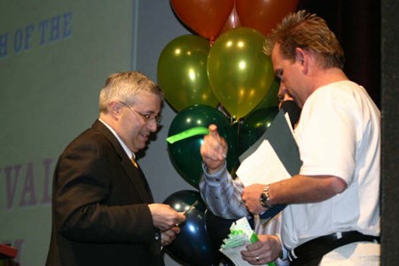 <b>North Bay Mayor Vic Fedeli is first to purchase a Heritage Festival wristband from festival honorary chairman Scott Clark. Photo by Bill Tremblay, Special to BayToday.ca.</b>