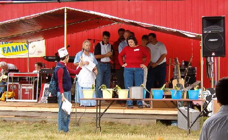 Nipissing MPP Monique Smith (in red shirt), Nipissing-Timiskaming MP Anthony Rota (in black and white shirt), Powassan Mayor Bob Young (behind Smith), Callander Mayor Bill Brazeau (back right), and Nipissing Mayor Wendy Billingsley (next to Brazeau), participate in a farmer's wife competition. Photo submitted.