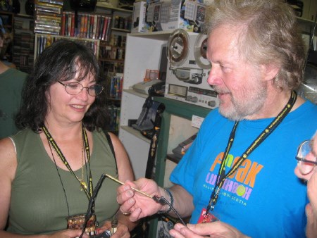 Randy Bachman displays a crossbow cord to his wife Denise McCann. Photo by Phil Novak.