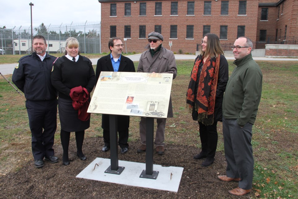 Officials gather around the new Heritage Site plaque at the North Bay Jail.  Photo by Chris Dawson/BayToday.ca 