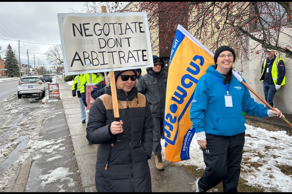 Local 576 President Cara-Lee Lyttle (on right), leads Canada Post workers as they picket outside the office on Worthington and Ferguson Streets.