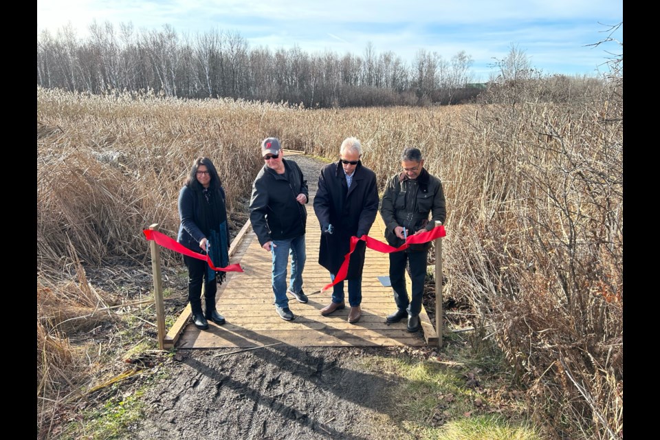 Chitra Gowda, Dave Britton, Mayor Peter Chirico and Fred Pinto cut the ribbon to officially unveil the new boardwalks at Laurier Woods. Photo by Chris Dawson/BayToday. 