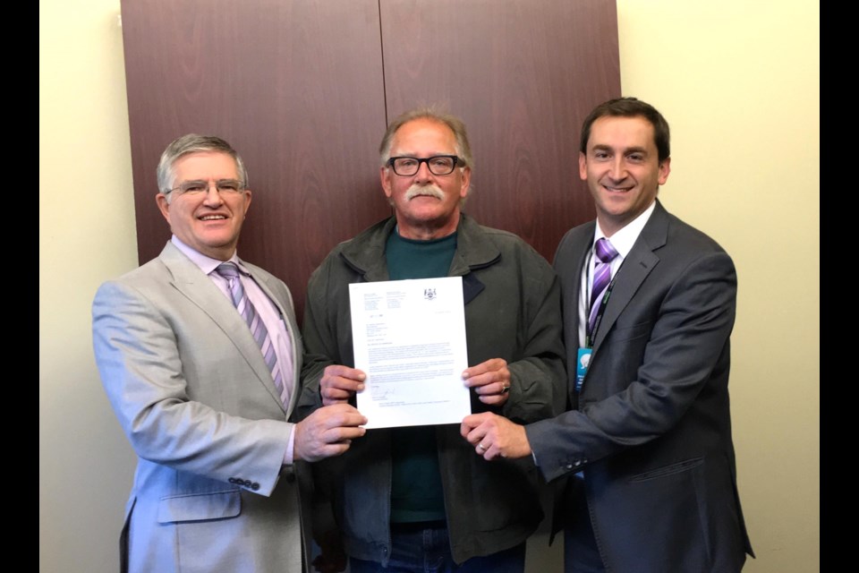 Happily showing off the approval letter is, left to right: René Maheu, Board Member, Wayne Powell, Board Chair and Jeremy Stevenson, President & CEO/Administrator