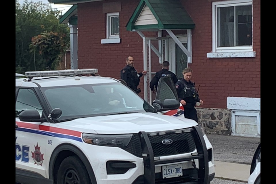 Police stand ready at an incident on Morin St. this morning.