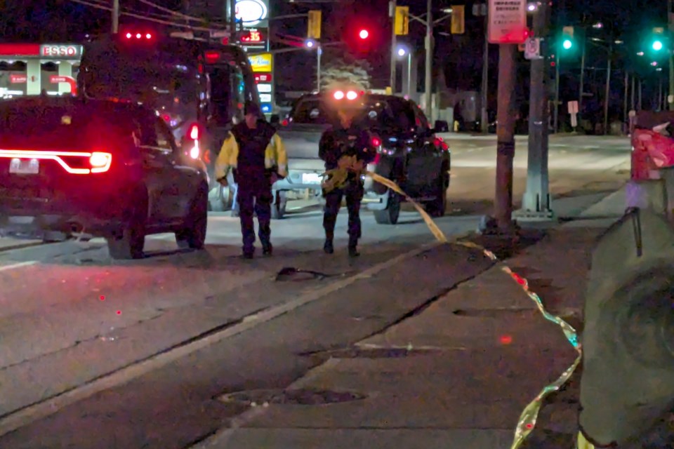 An NBPS officer takes down the yellow police tape as the investigation winds down.