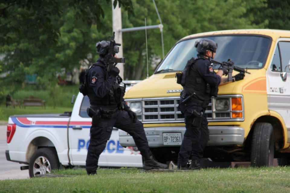 Heavily armed police officers at an apartment building on Lakeshore Drive.