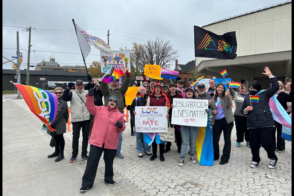 A larger crowd organized by OutLOUD North Bay enthusiastically waved signs outside City Hall.