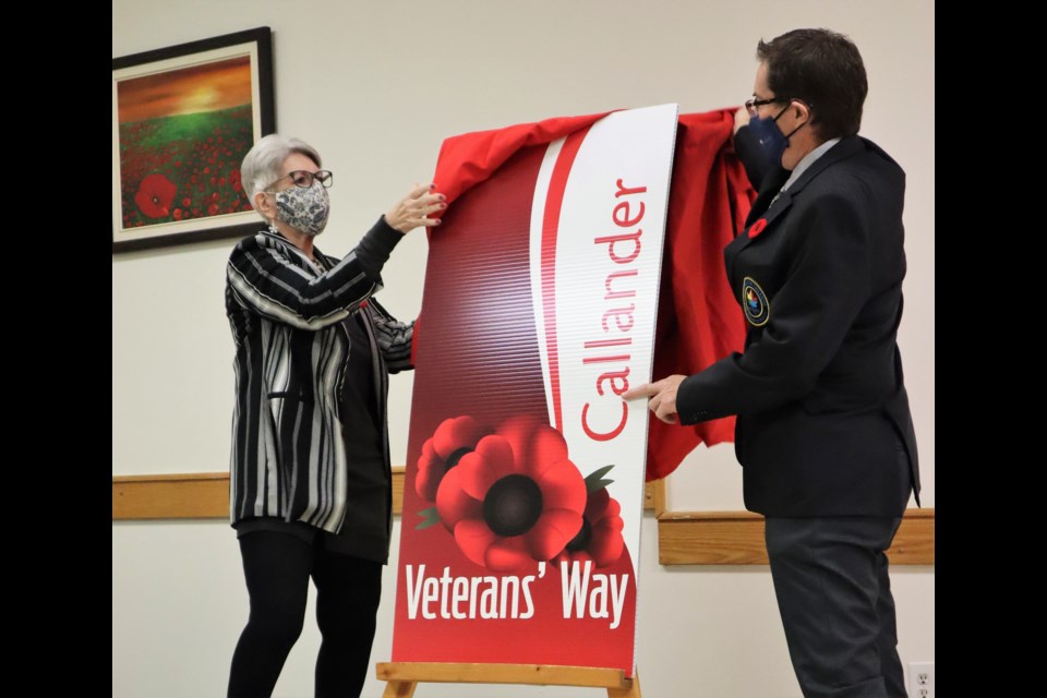 Lynne Lavigne, left, and Callander Mayor Robb Noon unveil the Veterans' Way banner during the annual Poppy Campaign launch at Legion Br. 445, Friday. Dave Dale Photo