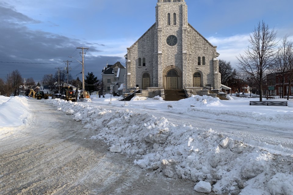 City crews remove snow from the streets surrounding the Pro Cathedral Tuesday morning.