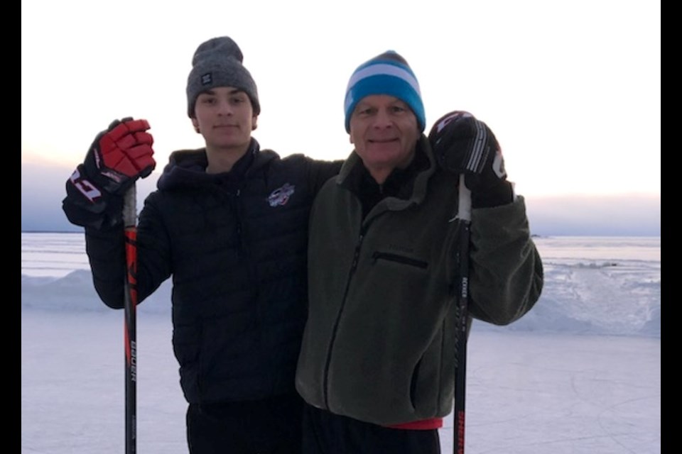 Wyatt Johnston and his dad Chuck Johnston on Lake Nipissing playing pond hockey.  Photo submitted. 