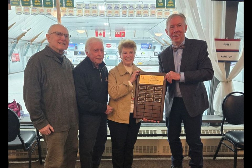 Peter Finch and Jack Phillips of the Seniors Section of the North Bay Granite Club presenting the Milt Colyer Award to Jack and Bea Lockhart.