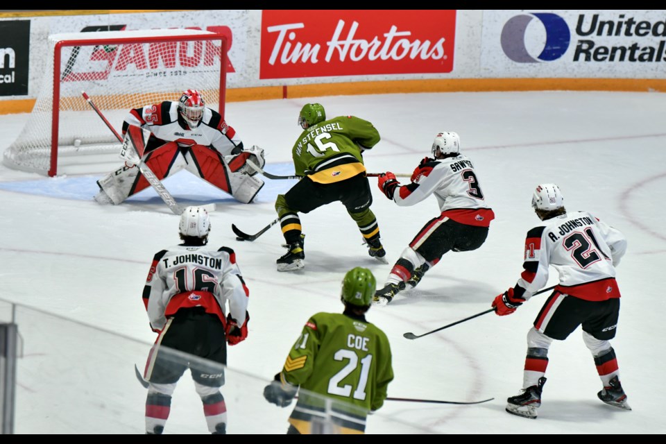 Owen Van Steensel is hauled down late in the third period. Photo by Tom Martineau/BayToday. 