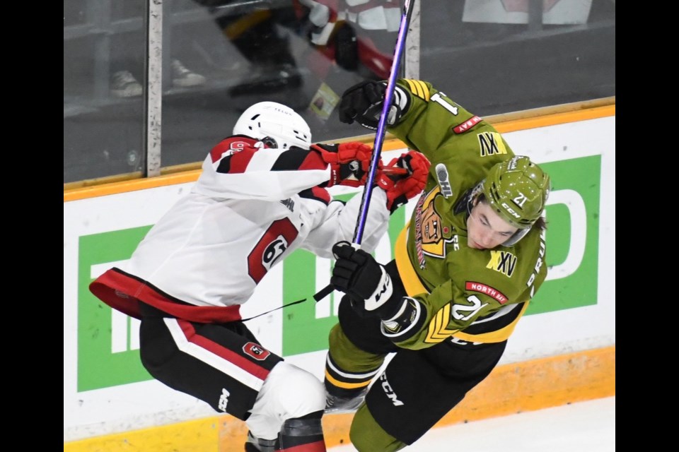 Battalion rookie Ethan Procyszyn gets knocked off the puck. Photo courtesy Sean Ryan. 