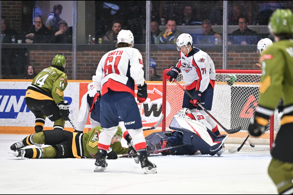 Wakely slides the puck past the Windsor goalie. Photo by Tom Martineau/BayToday. 