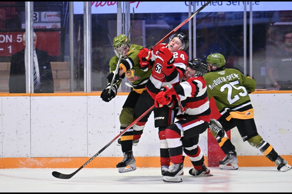 A collision at centre ice during first period action. Photo by Tom Martineau/BayToday. 