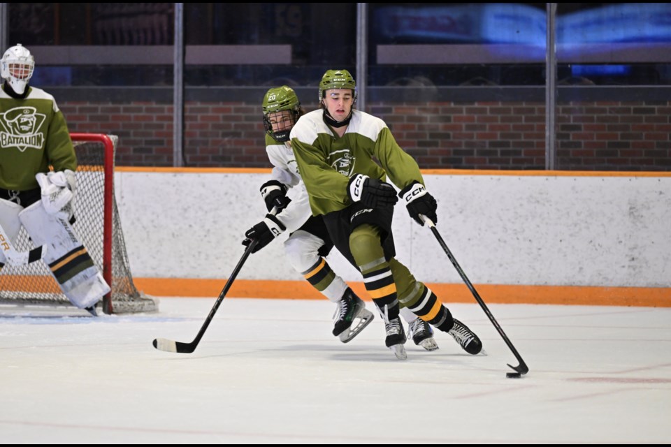 Wyatt Kennedy plays the puck in front of his net during a Green vs White scrimmage at Memorial Gardens during North Bay Battalion main camp. 