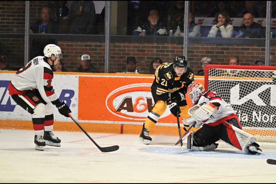 Ethan Procyszyn tries to jam the puck past 67s goaltender Colin McKenzie. 