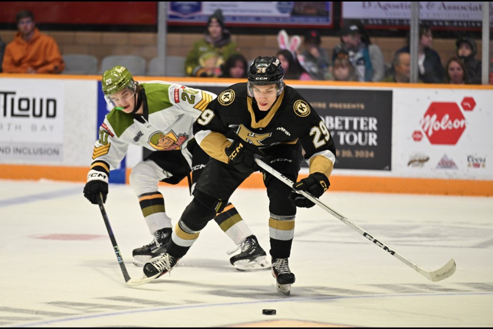 Lirim Amidovksi tries to knock the puck off the Fronts Luke McNamara. 