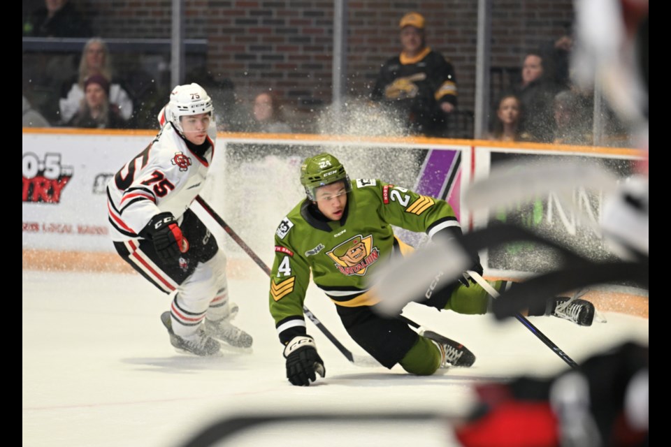 Shamar Moses tries to manage the puck while falling down. 