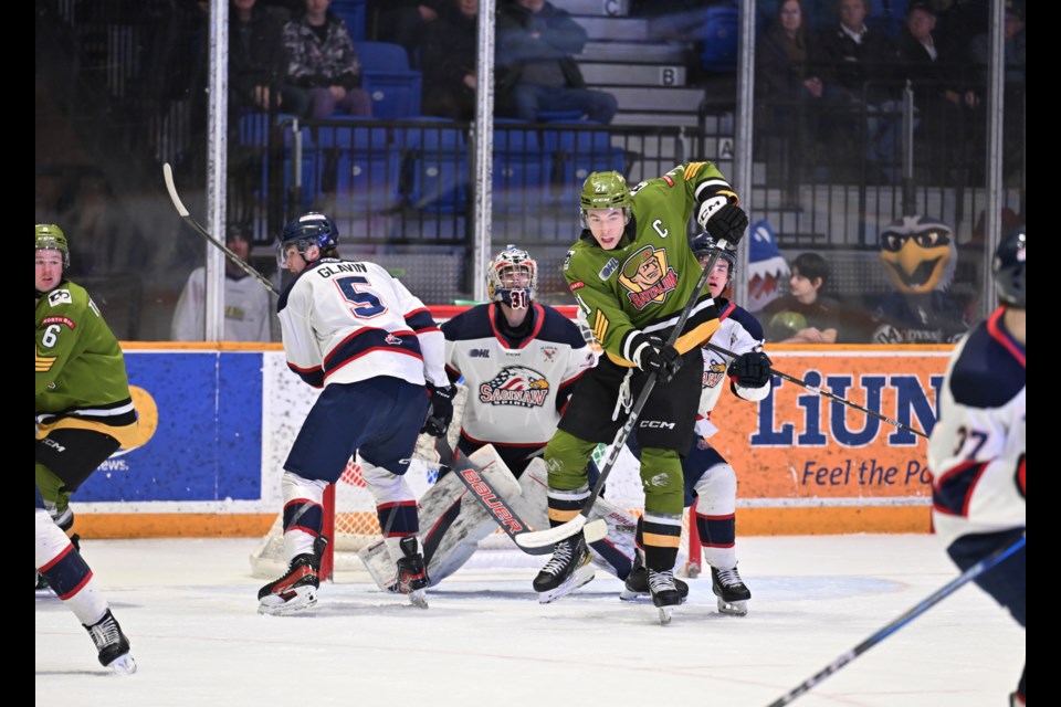 Ethan Procyszyn providing a screen in front of former Trappers netminder Kaleb Papineau. Photo courtesy Tom Martineau.