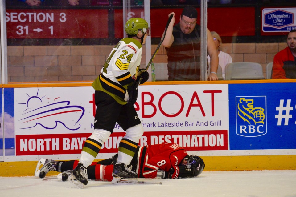 Brad Chenier skates past Owen Sound Attack defenceman Santino Centorame. The Attack player was leveled by The Battalion's Brett McKenzie, which resulted in a game misconduct. Photo by Tom Martineau