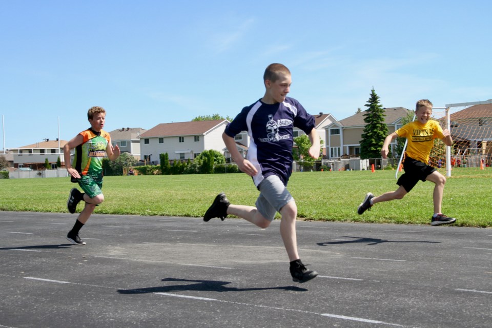 Young athletes race to the finish line in the 200 M sprint.  Photo by Chris Dawson.  