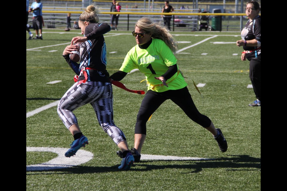 Tiffany MacKinnon of Spotted Moose Mixed makes the tackle in Pro Sports Management's Flag Football League action. Photo by Brian Risk