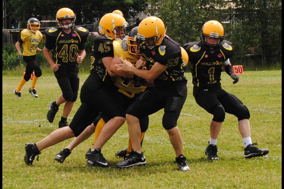 Bantam Bulldogs Peyton Killingsworth (#1), Nathaniel Major (#40), Chase McLeod (#59), and Colton Boucher (#45) involved in a tackle.  Photo submitted. 
 