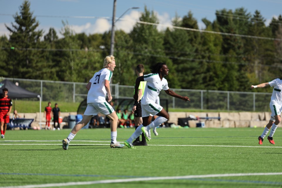 Caelan Walraven and Olutosin (Tosin) Ajakaiye celebrate a goal against the Ravens. 