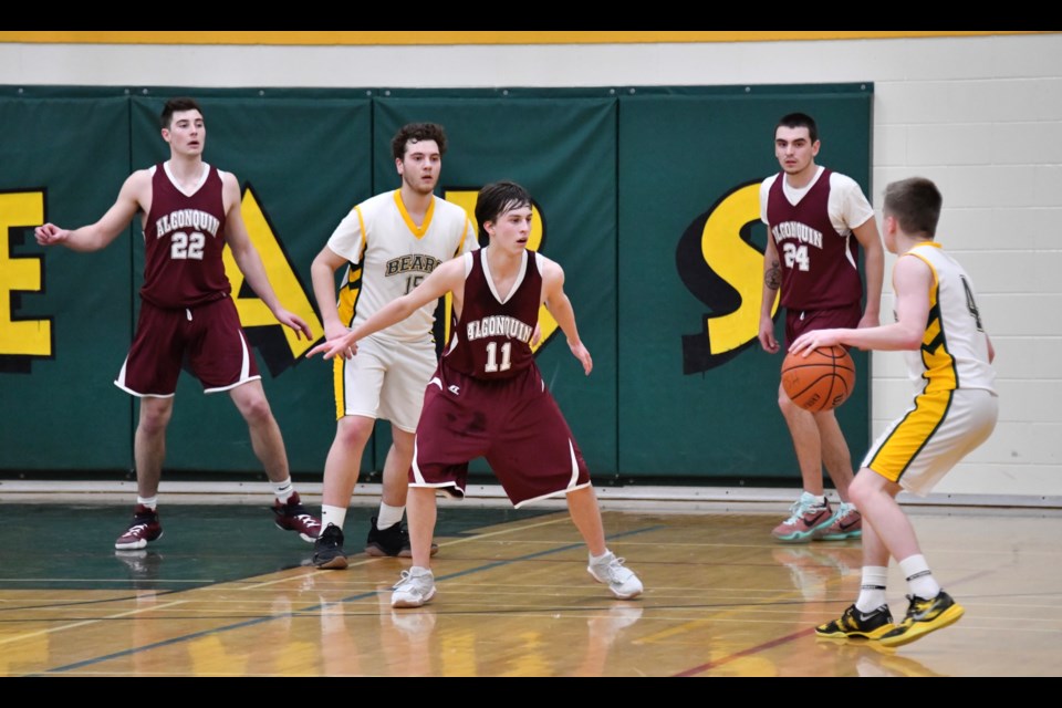 Algonquin Barons’ #11 Taylor Martineau guards the Bears’ #4 John Merkley in the fourth quarter.  In the background are #22 Zach Martel, #15 Steve Area and # 24 Matt Ranger. Photo by Tom Martineau. 