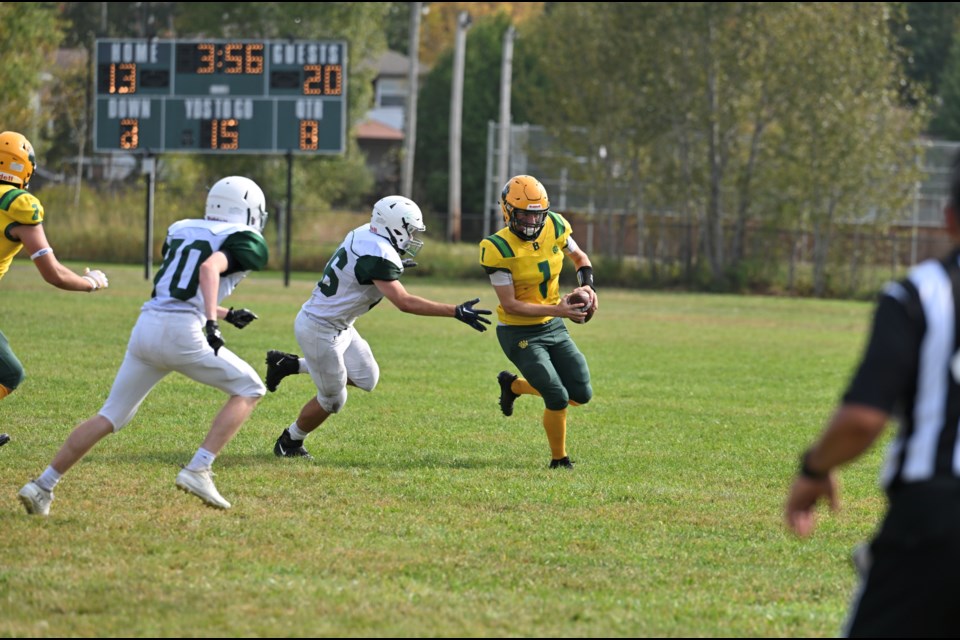 Bears quarterback Justin Marietti eludes a tackle. 