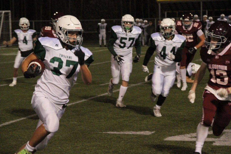 The Trojans Carson Sagle trying to get to the outside during a first quarter drive. 