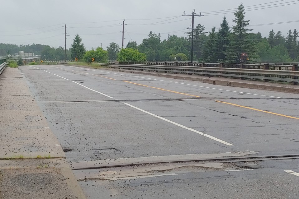 A consultant's report states the service life of the Lamorie Street bridge could be extended by 15-20 years via rehabilitation, including concrete patchwork and crack injections to the deck, waterproofing and paving, replacing expansion joint elastomeric strip seals, and replacing the steel railing system.