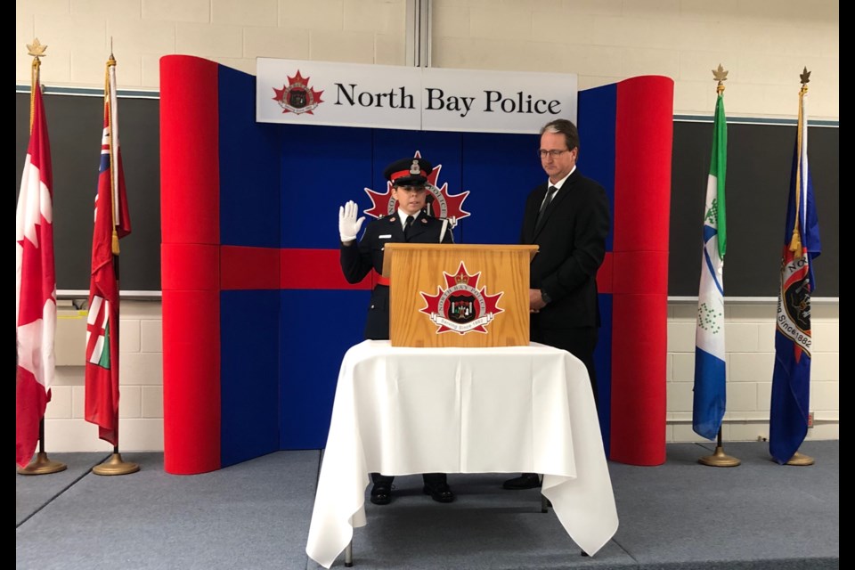 New constable Erin Bedard is sworn in by City Solicitor Peter Leckie.