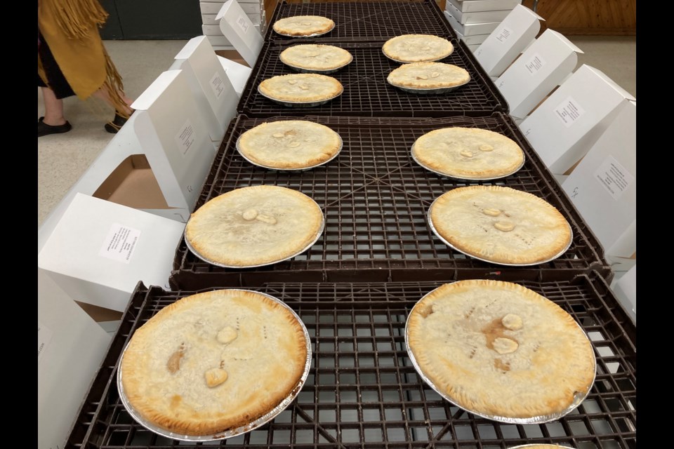 Regular, garlic, and extra-garlic meat pies lined up following a day of baking at the West Ferris Legion 