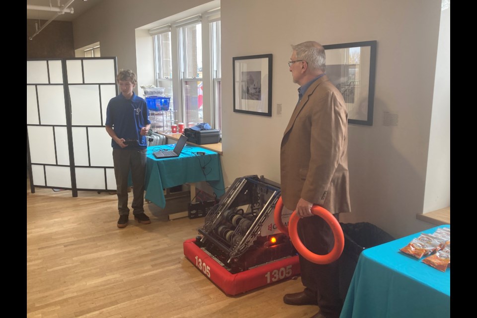 FIRST Robotics Team 1305 member gives students a robotics demonstration.