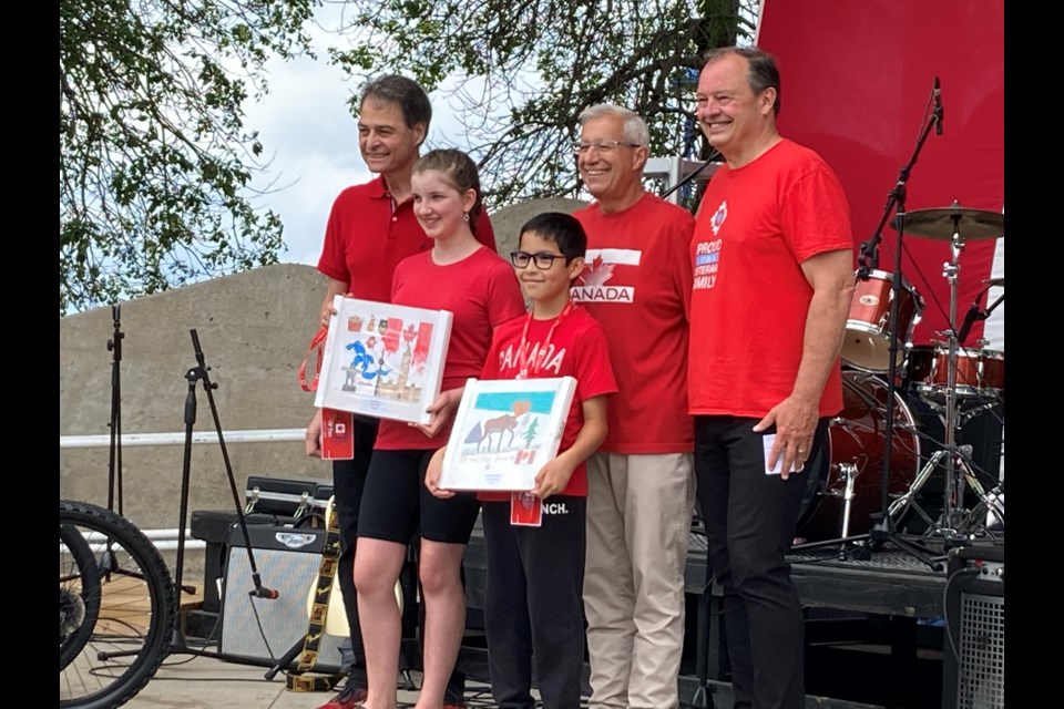 Two winners of the Canada Day elementary school poster contest pose with the (l-R) Nipissing-Timiskaming MP, Nipissing MPP and North Bay Mayor 