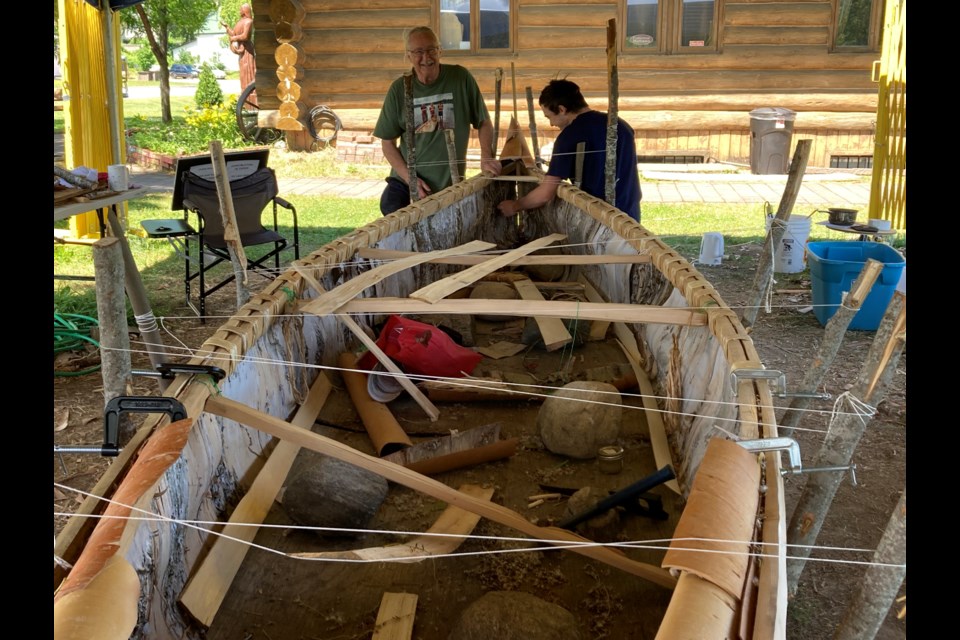 Marcel Labelle (l) and grandson Alexandre Labelle build birch bark canoe by hand for trip to National Day for Truth and Reconciliation in Ottawa, on September 30th