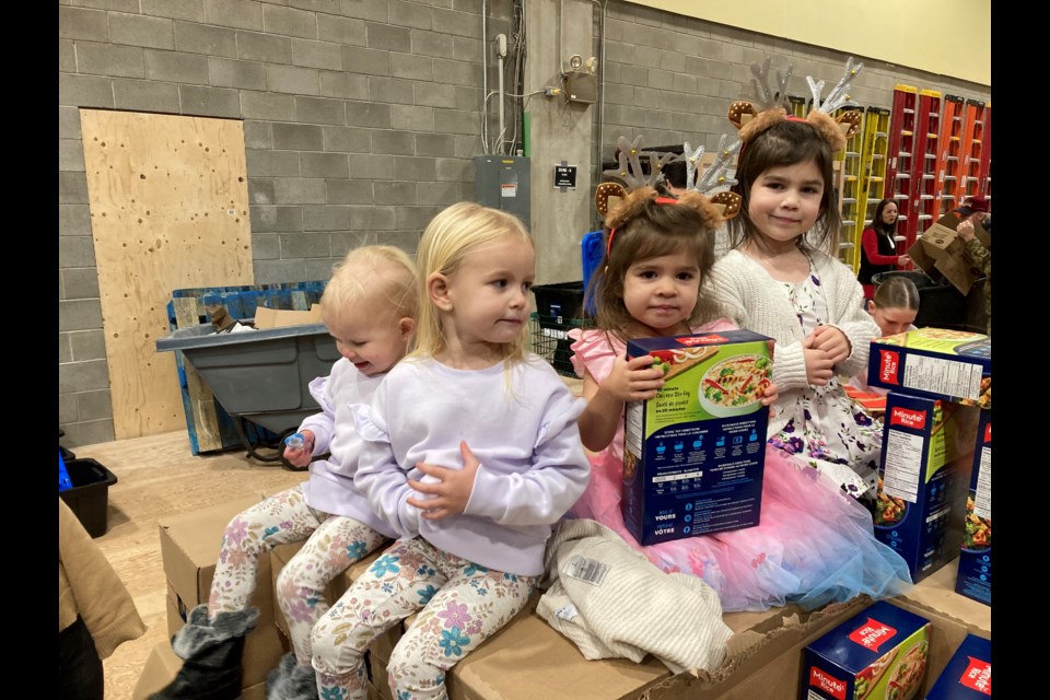 Families of all ages helped pack hampers for the North Bay Santa Fund.