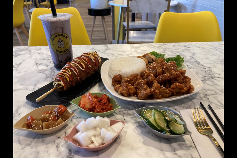 Gangnam Korea dishes; boneless gangnam chicken and rice with sides, bubble tea, and Mozza-dog combo  