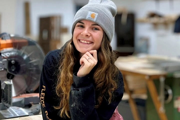 A portrait of the artist in her wood shop 