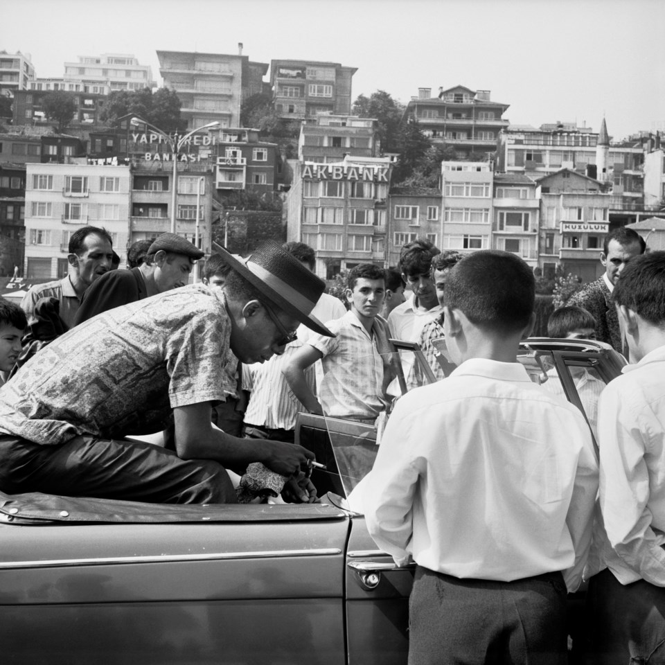 baldwin-sitting-in-a-triumph-herald-on-the-bosporus-ferry-photo-by-sedat-pakay