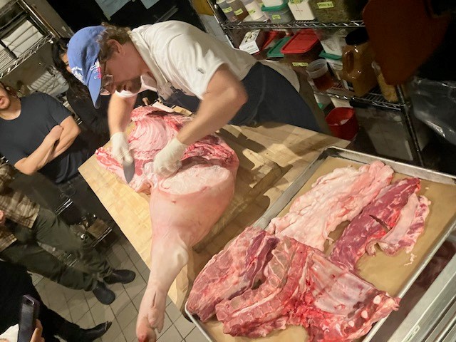 Chef Greg Little of Leland Eating and Drinking House in Prospect Heights showing guests the art of butchering a pig. 