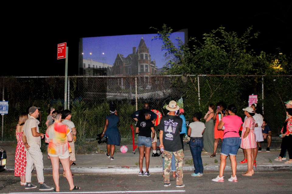 Residents commemorate the one year anniversary of the demolition of 441 Willoughby Avenue with a projection presentation.