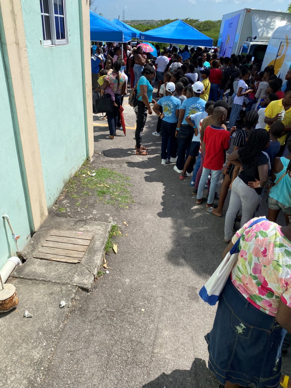 long-line-of-students-awaiting-backpacks