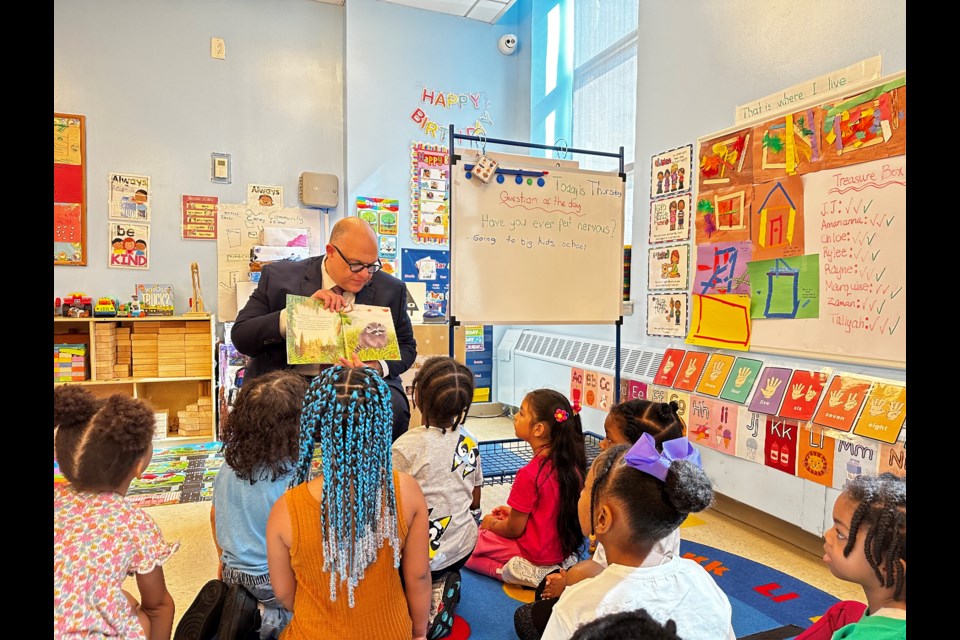 City Councilmember Justin Brannan reading to children at the Coney Island YMCA.