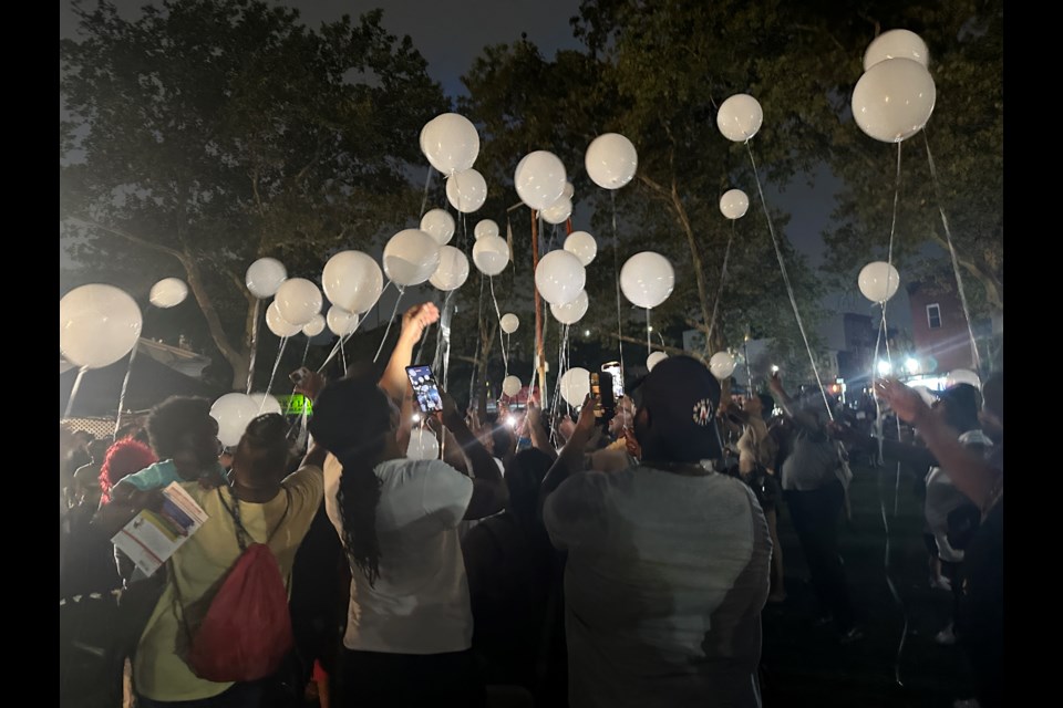 Family members of Davell Gardner send off balloons in his honor.