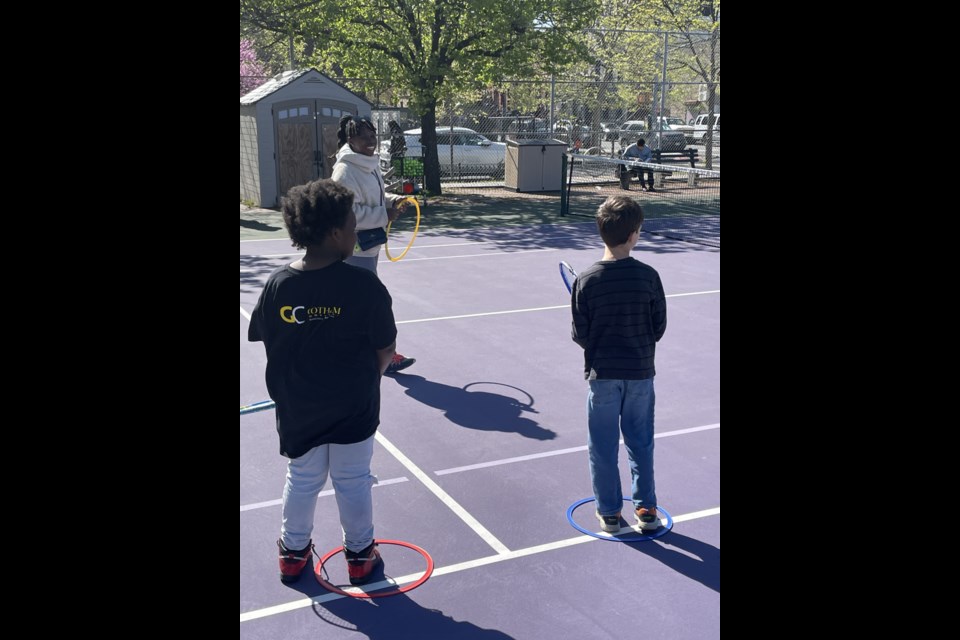 HQ Tennis Owner Frances Ferdinand teaches a children's program.