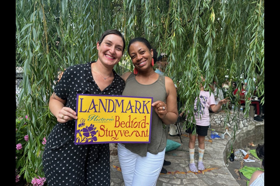 Lauren Cawdry and Charyl Pitts-Howard celebrate the designation of the Willoughby and Hart Streets between Nostrand and Marcy Avenues as an historic district by the Landmarks Preservation Commission