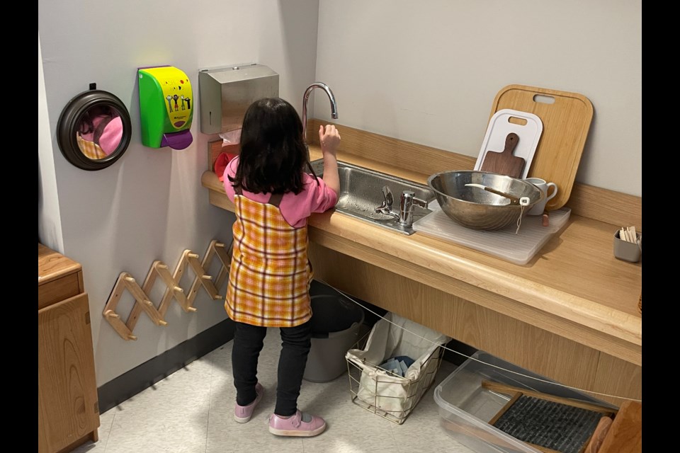 A student at the Albee Square Montessori P.S. 482 washes dishes as part of the Montessori philosophy of respecting surroundings.